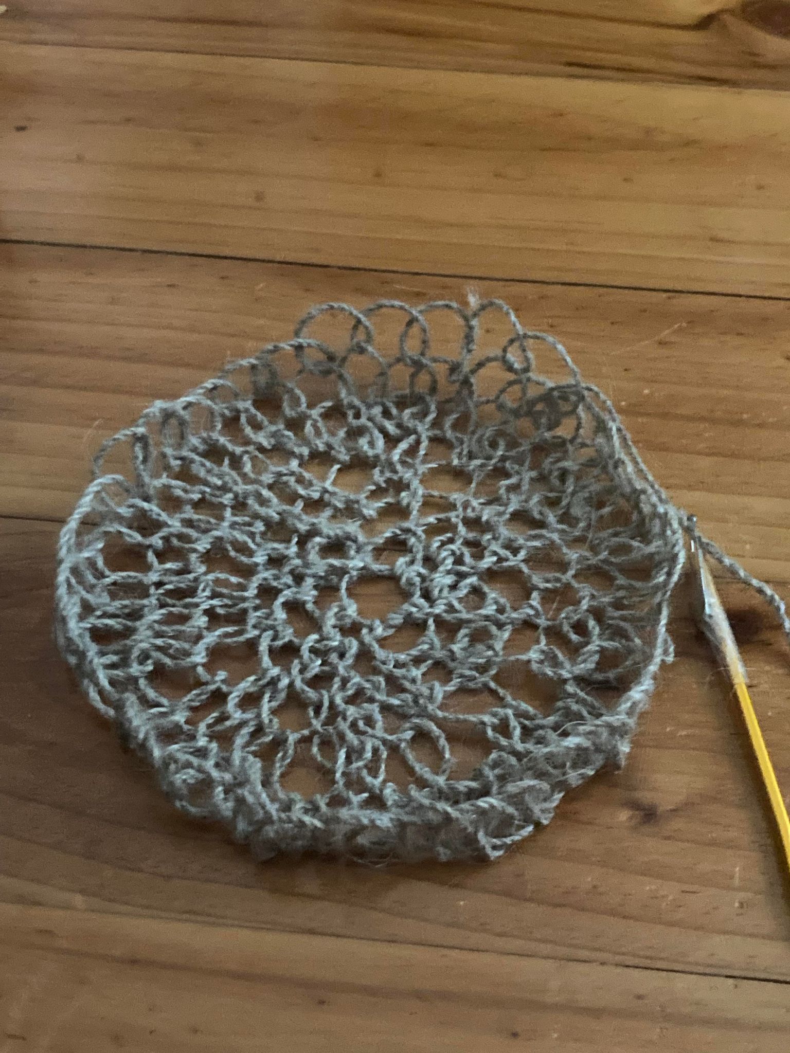 The beginnings of a circular net made of woven flax.